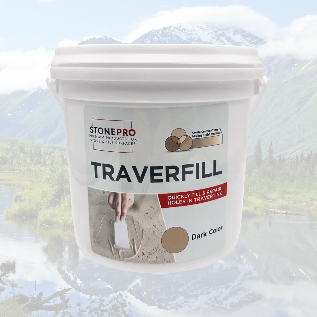 A white plastic bucket of StonePro TraverFill stone filler, labeled 'Dark Color', set against a blurred background of a mountain lake landscape.